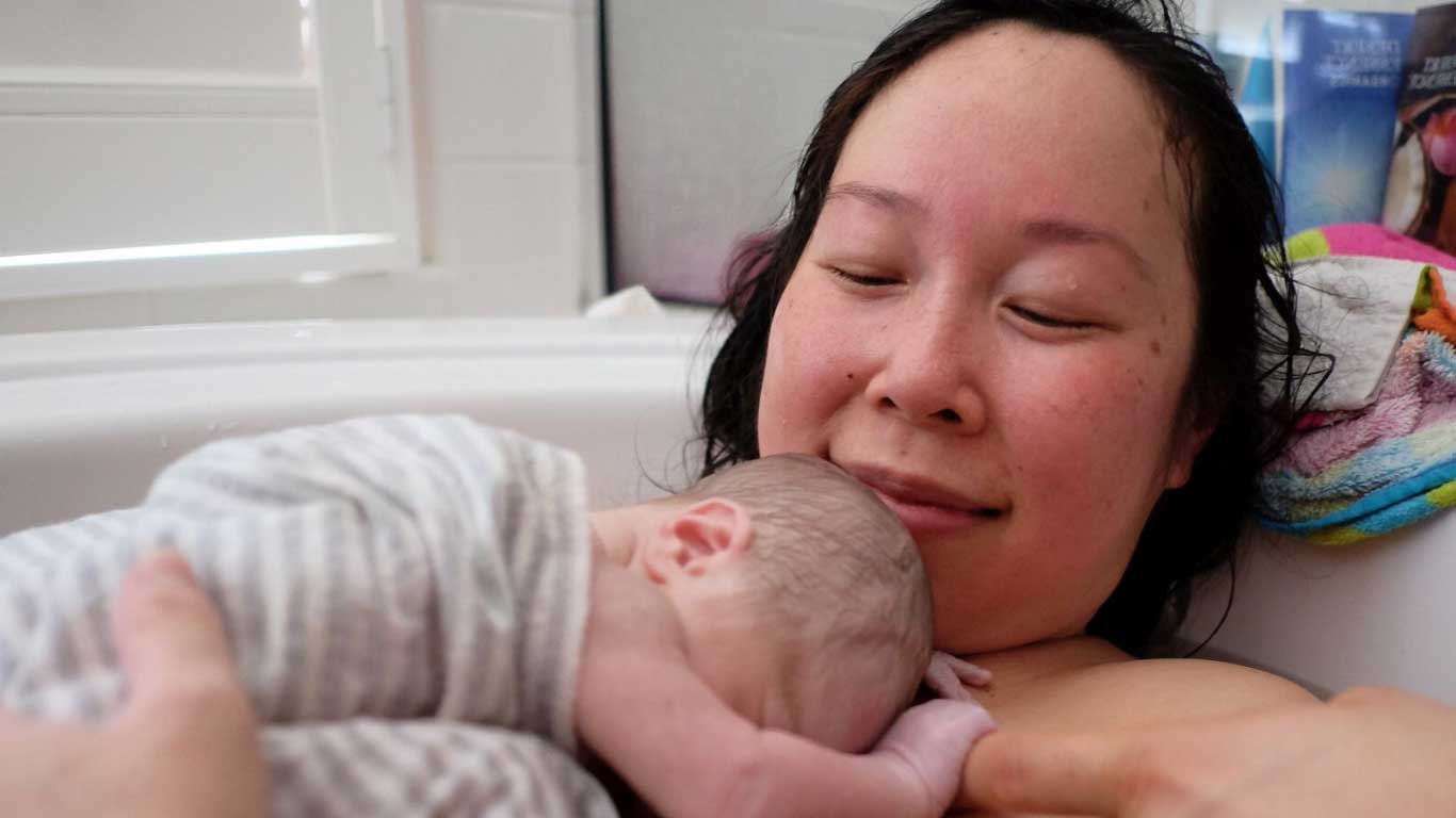 A mother holding her newborn baby